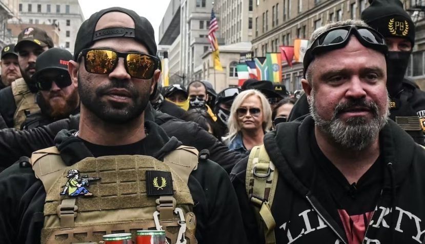 Enrique Tarrio, leader of the Proud Boys, at left, and group member Joe Biggs were sentenced to many years in federal prison. Stephanie Keith/Getty Images