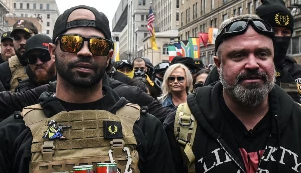 Enrique Tarrio, leader of the Proud Boys, at left, and group member Joe Biggs were sentenced to many years in federal prison. Stephanie Keith/Getty Images