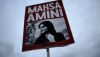 A placard with a picture of Mahsa Amini, whose death while being detained by Iran’s morality police has ignited a wave of protests across the country. (AP Photo/Markus Schreiber)