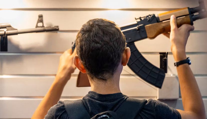 A boy examines a gun at the National Rifle Association annual convention on May 28, 2022, in Houston. Brandon Bell/Getty Images