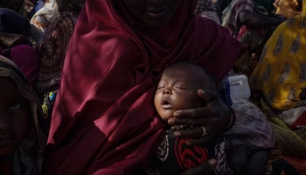 Mother and baby take refuge from drought and hunger at a refugee camp in Somalia. Giles Clarke via Getty Images