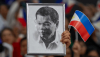 A supporter holds a portrait of former Philippine President Rodrigo Duterte at a campaign rally in Hong Kong Southorn Stadium on March 9, 2025. Anthony Kwan/Getty Images