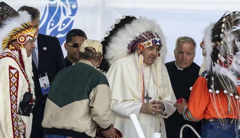 Pope Francis receives a traditional headdress after apologizing near the site of the former Ermineskin Residential School, in Maskwacis, Alta. THE CANADIAN PRESS/Jason Franson