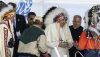 Pope Francis receives a traditional headdress after apologizing near the site of the former Ermineskin Residential School, in Maskwacis, Alta. THE CANADIAN PRESS/Jason Franson