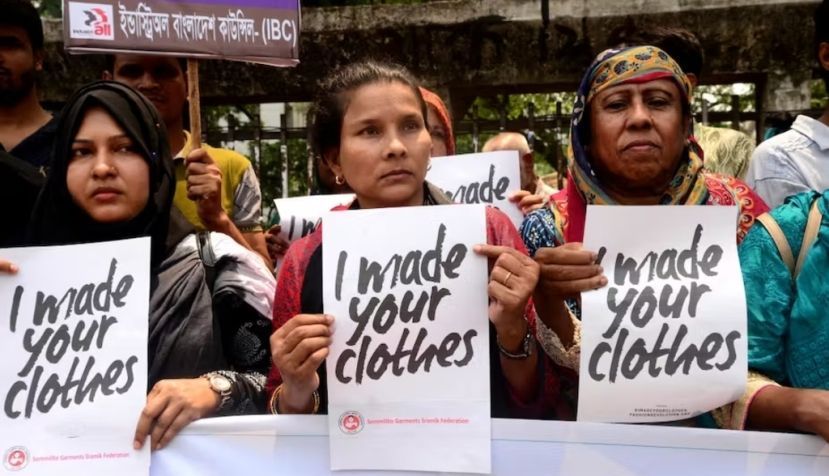  Three women at the front of a protest hold signs saying 'I made your clothes.' Activists in Dhaka demand safe working conditions in 2019, on the anniversary of the Rana Plaza collapse. Mamunur Rashid/NurPhoto via Getty Images