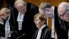 International Court of Justice President Joan Donoghue, center, and other judges arrive prior to the preliminary order announcement on Jan. 26, 2024. Remko De Waal/ANP/AFP via Getty Images 