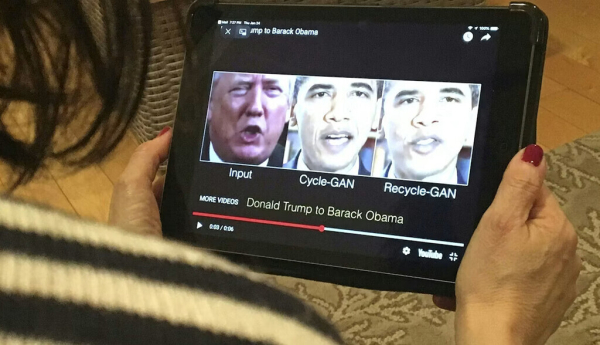 A woman views a manipulated video in January 2019 that changes what is said by President Donald Trump and former President Barack Obama, illustrating how deepfake technology can deceive viewers. Robe LeverAFP via Getty Images