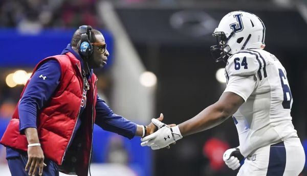 Jackson State Tigers coach Deion Sanders greets right tackle Deontae Graham during the Cricket Celebration Bowl on Dec. 17, 2022. Austin McAfee/Icon Sportswire via Getty Images