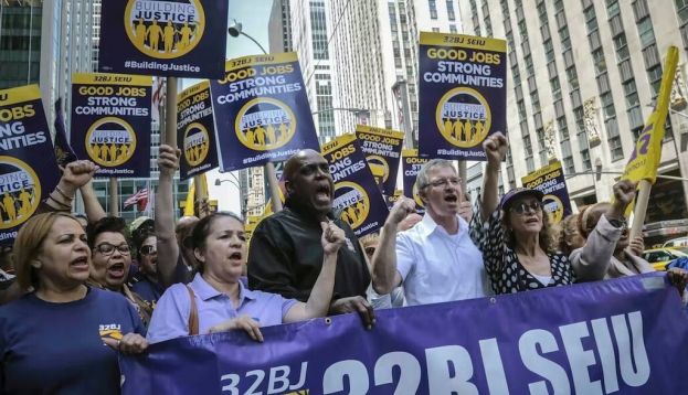 Members of a union representing workers who clean New York City offices march in 2019. AP Photo/Bebeto Matthews