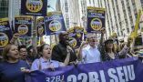 Members of a union representing workers who clean New York City offices march in 2019. AP Photo/Bebeto Matthews