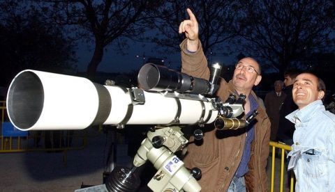 Dos aficionados a la astronomía observan el cielo desde la explanada del Planetario de Madrid. EFE/Archivo 