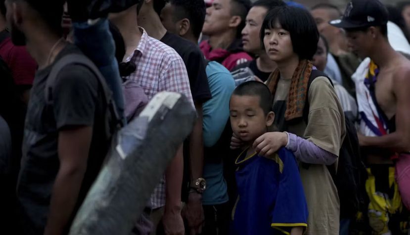 Chinese migrants wait for a boat after having walked across the Darien Gap from Colombia to Panama. AP Photo/Natacha Pisarenko