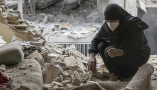 A woman sifts through the rubble in her home after it was damaged by a missile on March 15, 2026, in Tehran. Majid Saeedi/Getty Images