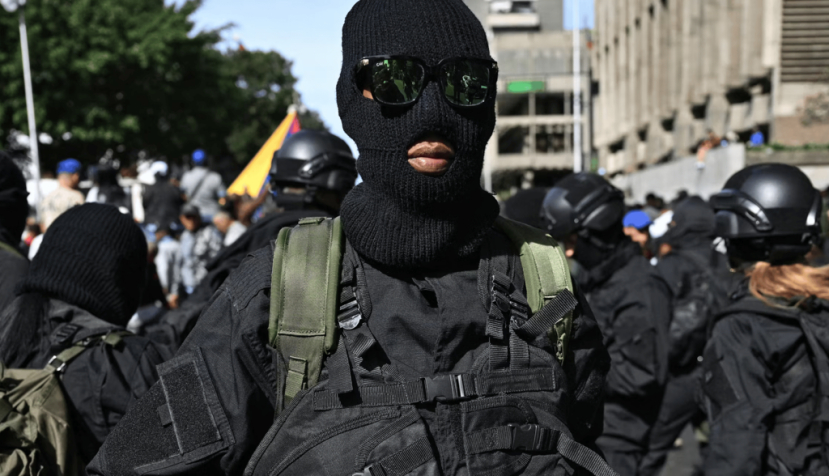 Armed supporters of Nicolás Maduro gather near the Miraflores presidential palace in Caracas on Jan. 3, 2026. Federico Parra/ AFP via Getty Images