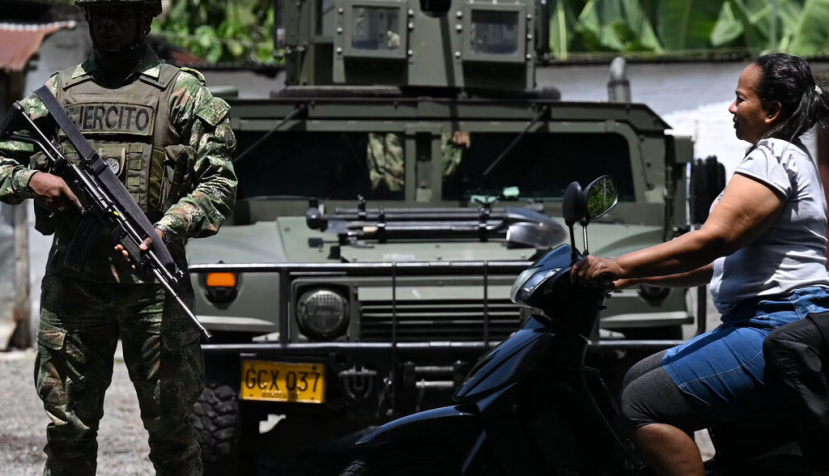 Soldiers guard a road after the Colombian government accused the Gulf Clan criminal organization of supporting attacks by illegal gold miners. Raul Arboleda/AFP via Getty Images