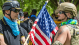 Anti-government protestors use the American flag to draw attention to their cause at a protest on Aug. 8, 2020, in Columbus, Ohio. Paul Becker/Becker 1999 via Flickr, CC BY