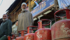 Customers stand with empty cooking-gas cylinders in Srinagar, India, waiting to be able to refill them. Firdous Nazir/NurPhoto via Getty Images