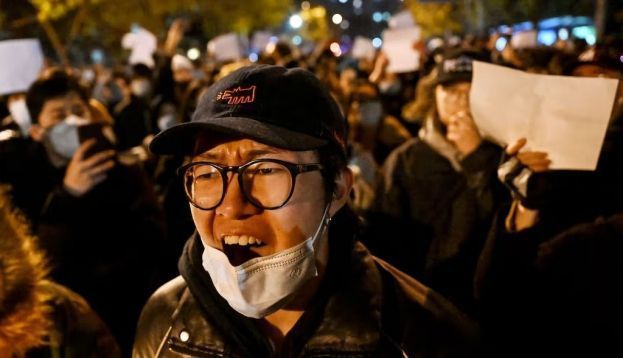 Protesters march along a street in Beijing on Nov. 28, 2022. Noel Celis/AFP via Getty Images