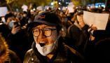 Protesters march along a street in Beijing on Nov. 28, 2022. Noel Celis/AFP via Getty Images