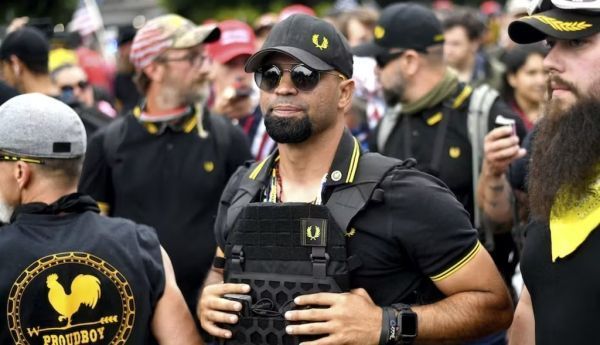 Enrique Tarrio, center, stands with other Proud Boys at a 2019 rally in Portland, Oregon. AP Photo/Noah Berger