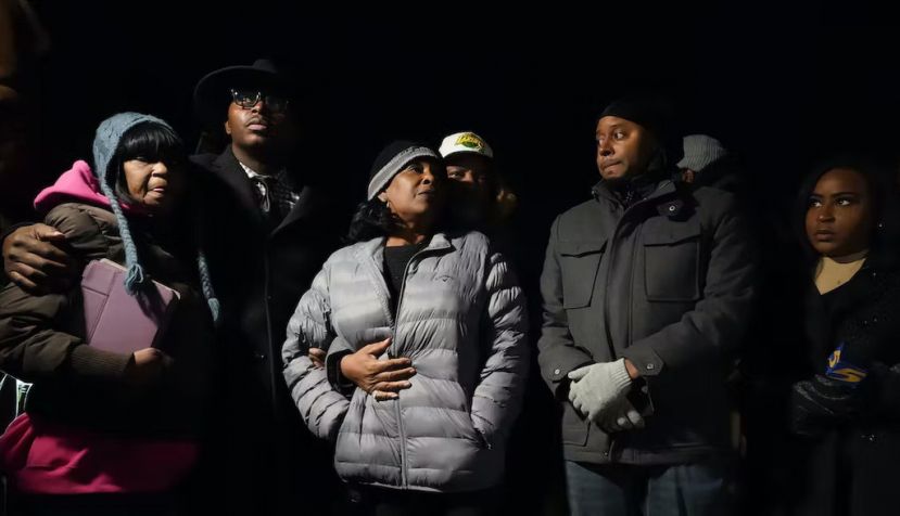 RowVaughn Wells, in gray jacket, mother of Tyre Nichols, who died after being beaten by Memphis police officers, is with friends and family members at the conclusion of a candlelight vigil for Tyre, in Memphis, Tenn., on Jan. 26, 2023. AP Photo/Gerald Herbert