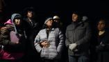 RowVaughn Wells, in gray jacket, mother of Tyre Nichols, who died after being beaten by Memphis police officers, is with friends and family members at the conclusion of a candlelight vigil for Tyre, in Memphis, Tenn., on Jan. 26, 2023. AP Photo/Gerald Herbert