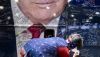 A person signs a bus wrapped with an image of former President Donald Trump during the Conservative Political Action Conference on Feb. 22, 2024. Brendan Smialowski/AFP via Getty Images