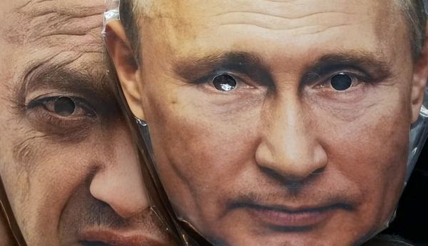 Face masks depicting Russian President Vladimir Putin and owner of private military company Wagner Group Yevgeny Prigozhin. AP Photo
