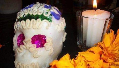 Detalle de un altar de muertos en Tabasco, México: Calavera de azúcar, flor de cempasúchitl y candela. Foto de Salvador alc.