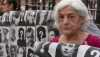 A protester holds a banner with pictures of people who went missing during the Spanish dictatorship of Francisco Franco. John Milner/SOPA Images/LightRocket via Getty Images