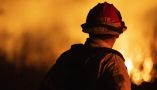 A firefighter surveys the destruction at the Auto Fire in Oxnard, Calif. Etienne Laurent/AFP via Getty Images