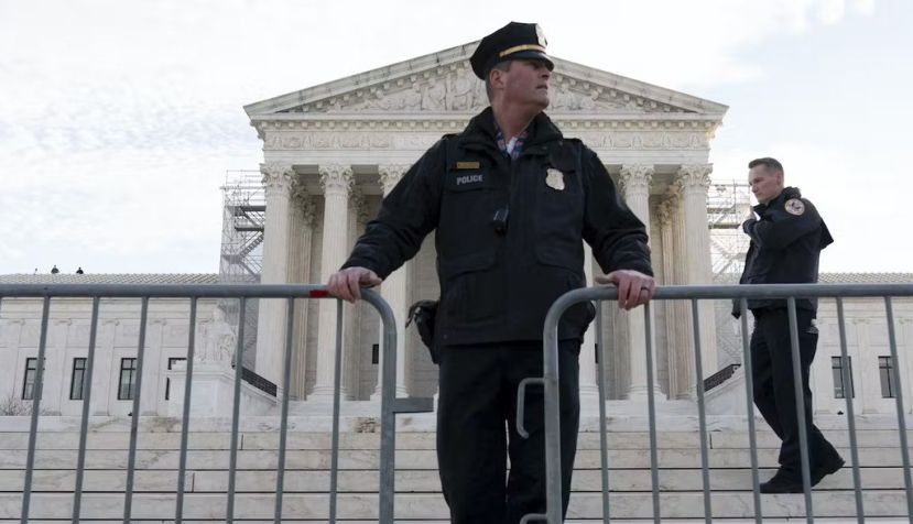 Police place a fence at the U.S. Supreme Court on Feb. 8, 2024, before justices heard arguments over whether Donald Trump is ineligible for the 2024 ballot. AP Photo/Jose Luis Magana
