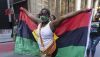 A supporter holds up a flag as she marches down the street celebrating Juneteenth, June 19, 2021, in Chicago, Ill. (Anthony Vazquez/Chicago Sun-Times via AP)