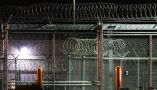 Barbed wire surrounds the GEO Group ICE detention facility in Adelanto, Calif. on July 10, 2025. Patrick T. Fallon/AFP via Getty Images