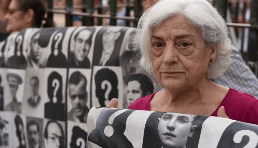 A protester holds a banner with pictures of people who went missing during the Spanish dictatorship of Francisco Franco. John Milner/SOPA Images/LightRocket via Getty Images